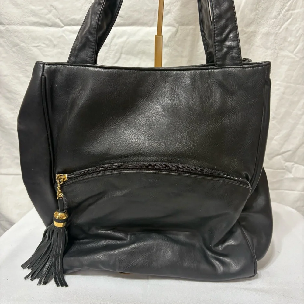 Black tote bag with a tassel accent. - Picture 3 of 12
